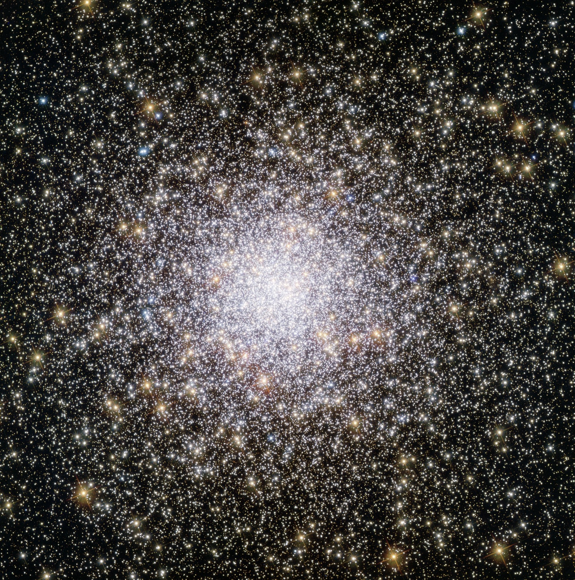 An irregular white glowing sphere surrounded by silver and gold orbs