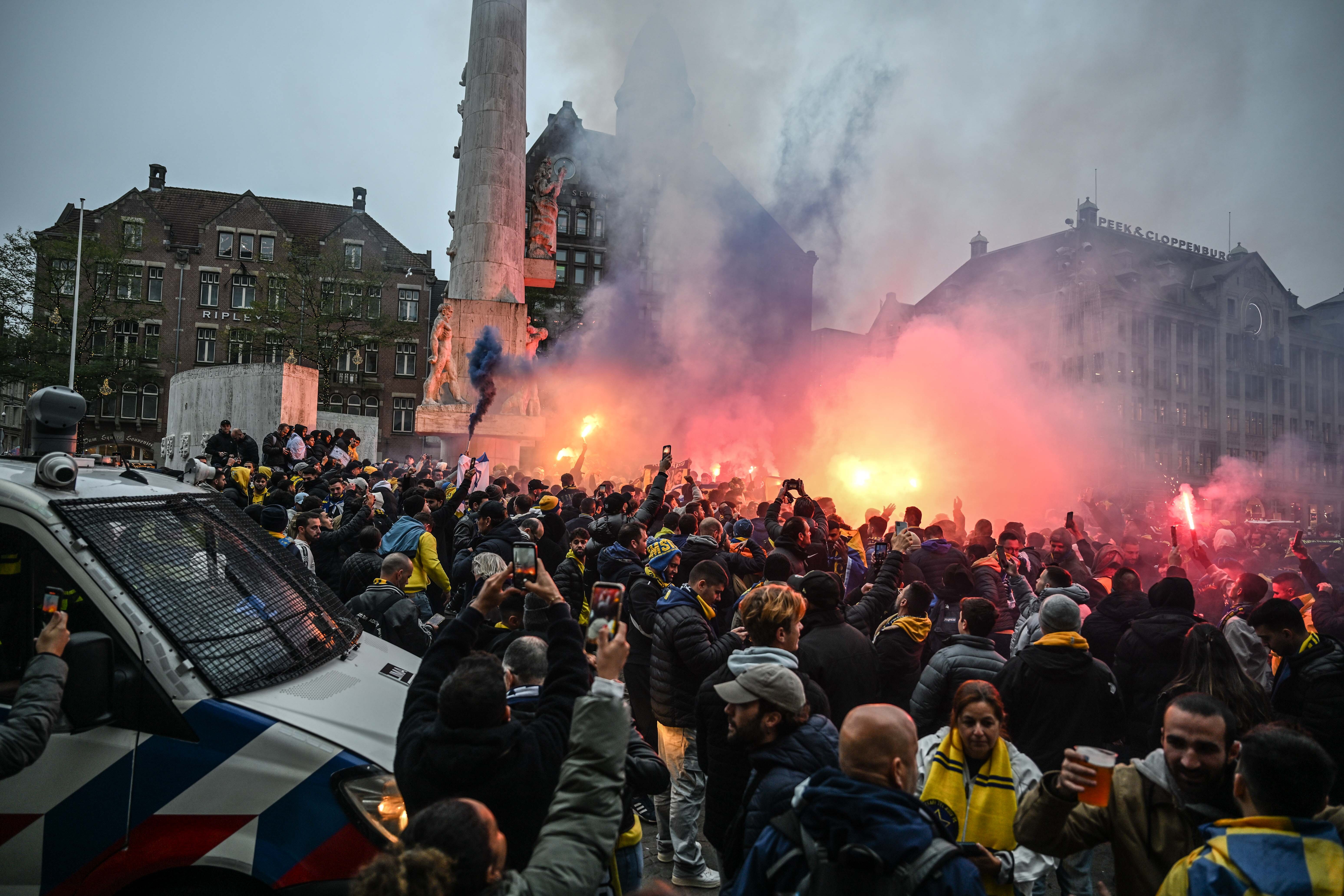 AMSTERDAM, NETHERLANDS - NOVEMBER 7: Fans of Maccabi Tel Aviv stage a pro-Israel demonstration at the Dam Square, lighting up flares and chanting slogans ahead of the UEFA Europa League match between Maccabi Tel Aviv and Ajax in Amsterdam, Netherlands on November 07, 2024. Maccabi fans clashed with pro-Palestinian citizens and ripped off Palestinian flags hung on the streets. In the lead-up to the Ajax vs Maccabi Tel Aviv match, several areas of Amsterdam have been designated as security risk zones. (Photo by Mouneb Taim/Anadolu via Getty Images)