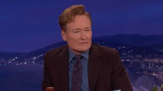 Conan O'Brien at his desk on Conan.