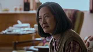 A close up shot of the elderly Ye Wenjie sitting on a couch in Netflix's 3 Body Problem