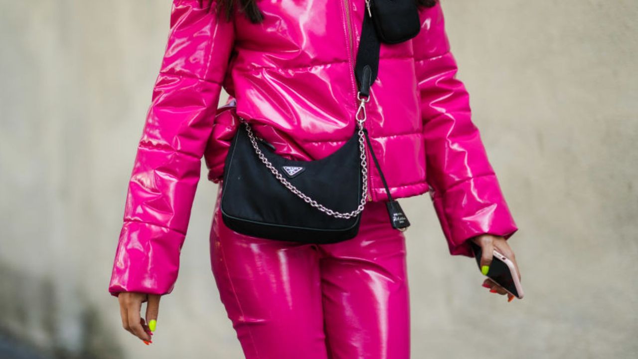 a woman walking with neon nails - neon nail designs