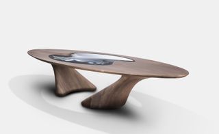 The dining table in the collection combines acrylic and walnut