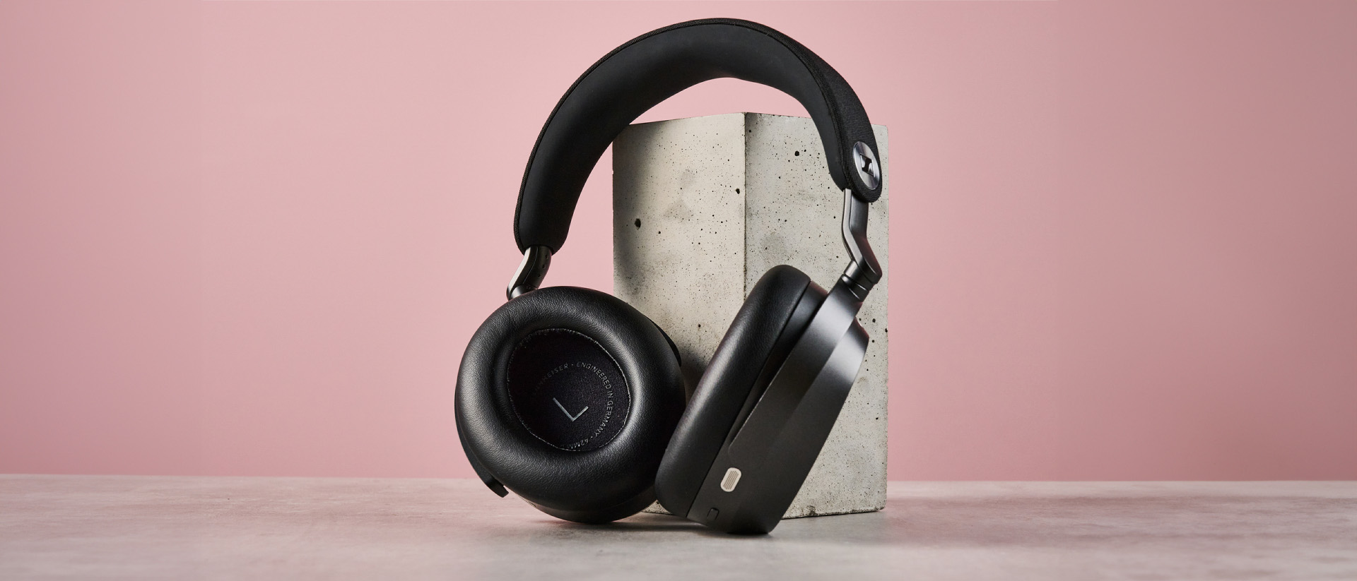 The Sennheiser Momentum 5 leaning against a concrete block.