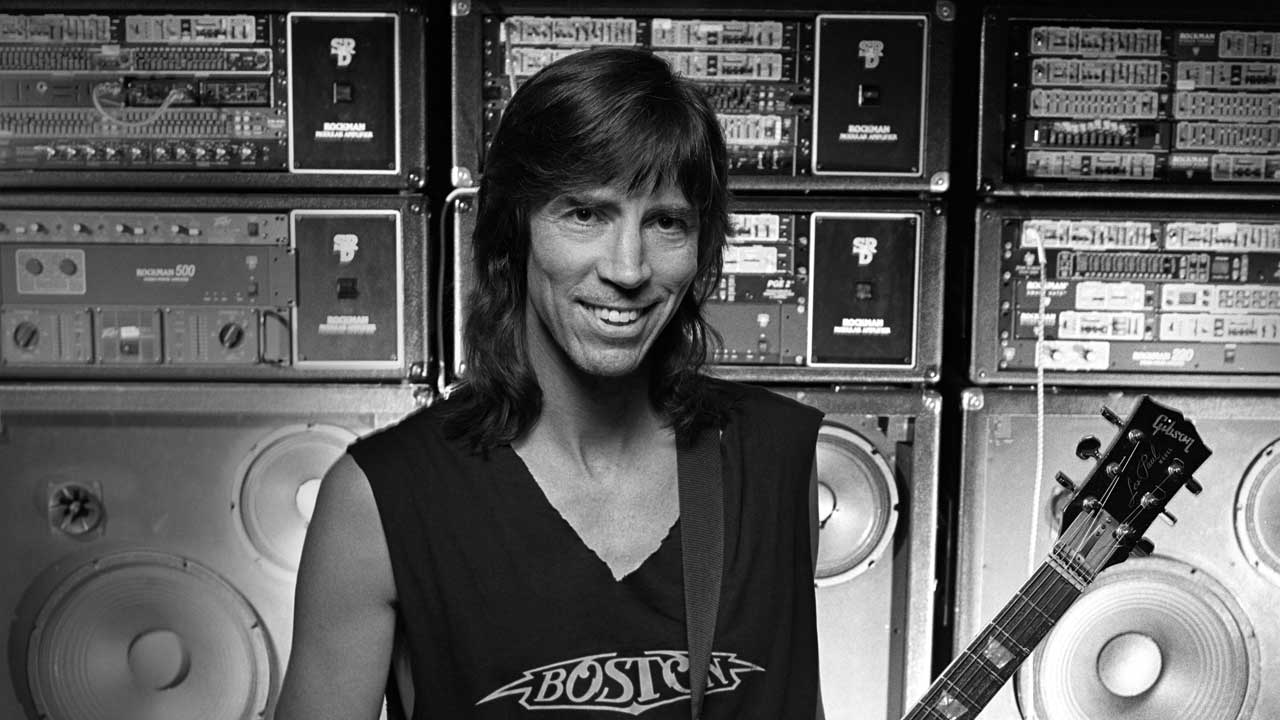 Tom Scholz in 1994 standing in front of a bank of equipment