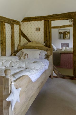 Cottage kid's room with wooden bed and beams