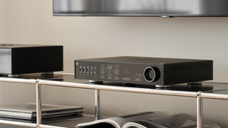 HiFi Rose RD160 DAC in black on a shelf under TV