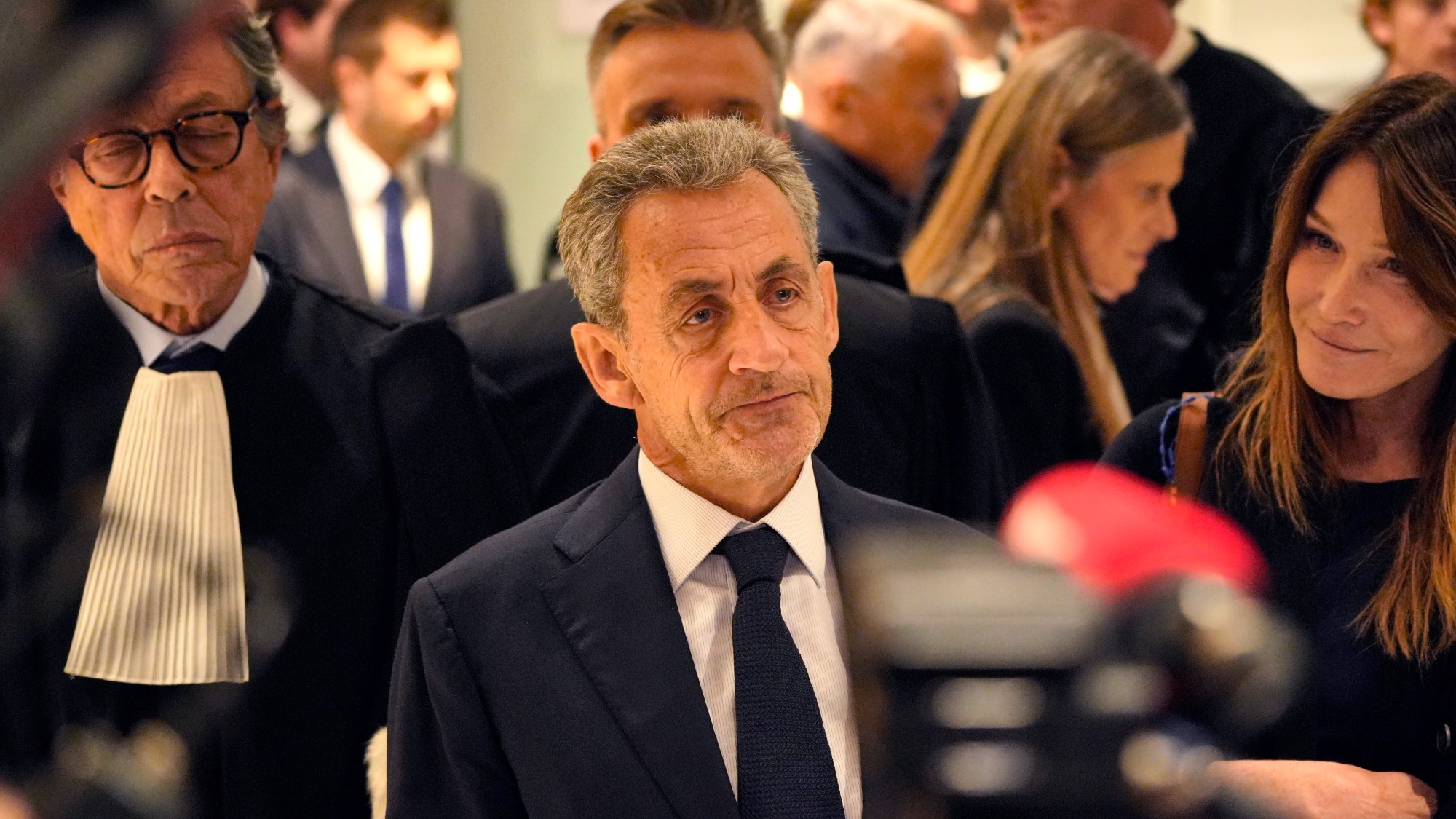 Nicolas Sarkozy in front of the press with wife Carla Bruni 