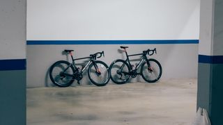 Two Colnagos against a wall at a distance