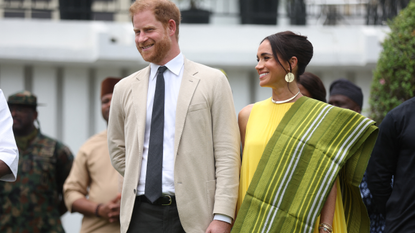 Britain's Prince Harry (2ndR), Duke of Sussex, and Britain's Meghan (R), Duchess of Sussex, react as Lagos State Governor, Babajide Sanwo-Olu (unseen), gives a speech at the State Governor House in Lagos