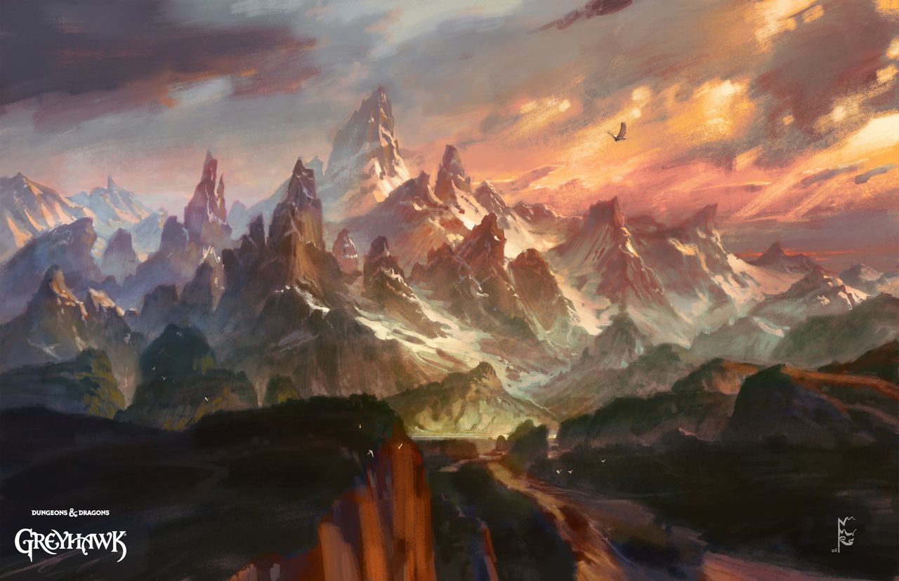 Sweeping, snow-covered mountains set against a fiery sunset