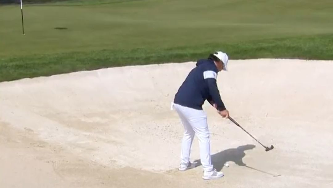 Ewen Ferguson takes a shot from a bunker with a putter at the 2023 Porsche European Open