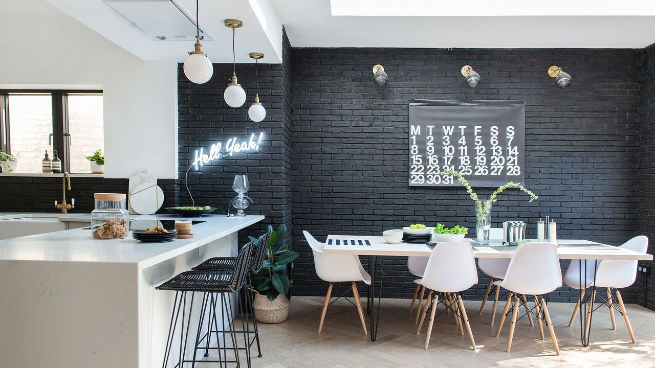 room with bar stools and black brick