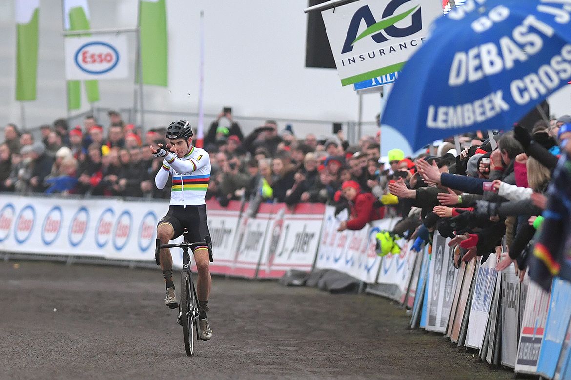 Woet Van Aert performs a shooting celebration as he nears the line