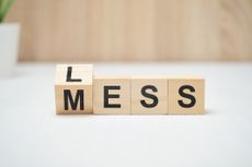 The words less mess on wooden blocks. Close up.