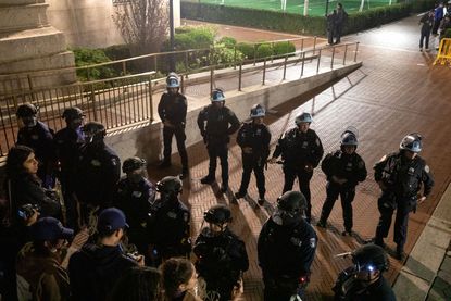 NYPD officers in riot gear enter Columbia University's encampment as they evict a building that had been barricaded by pro-Palestinian student protesters in New York City on April 30, 2024