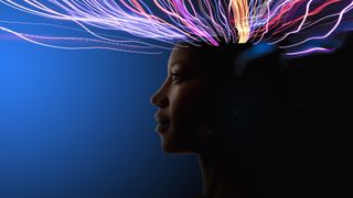 An image of a woman&#039;s face shown in silhouette with trails of light coming from the top of her head