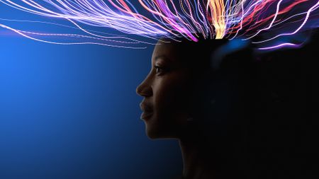 An image of a woman with trails of light coming from the top of her head