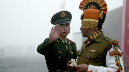 A Chinese border guard confronts an Indian solider at the ancient Nathu La border crossing