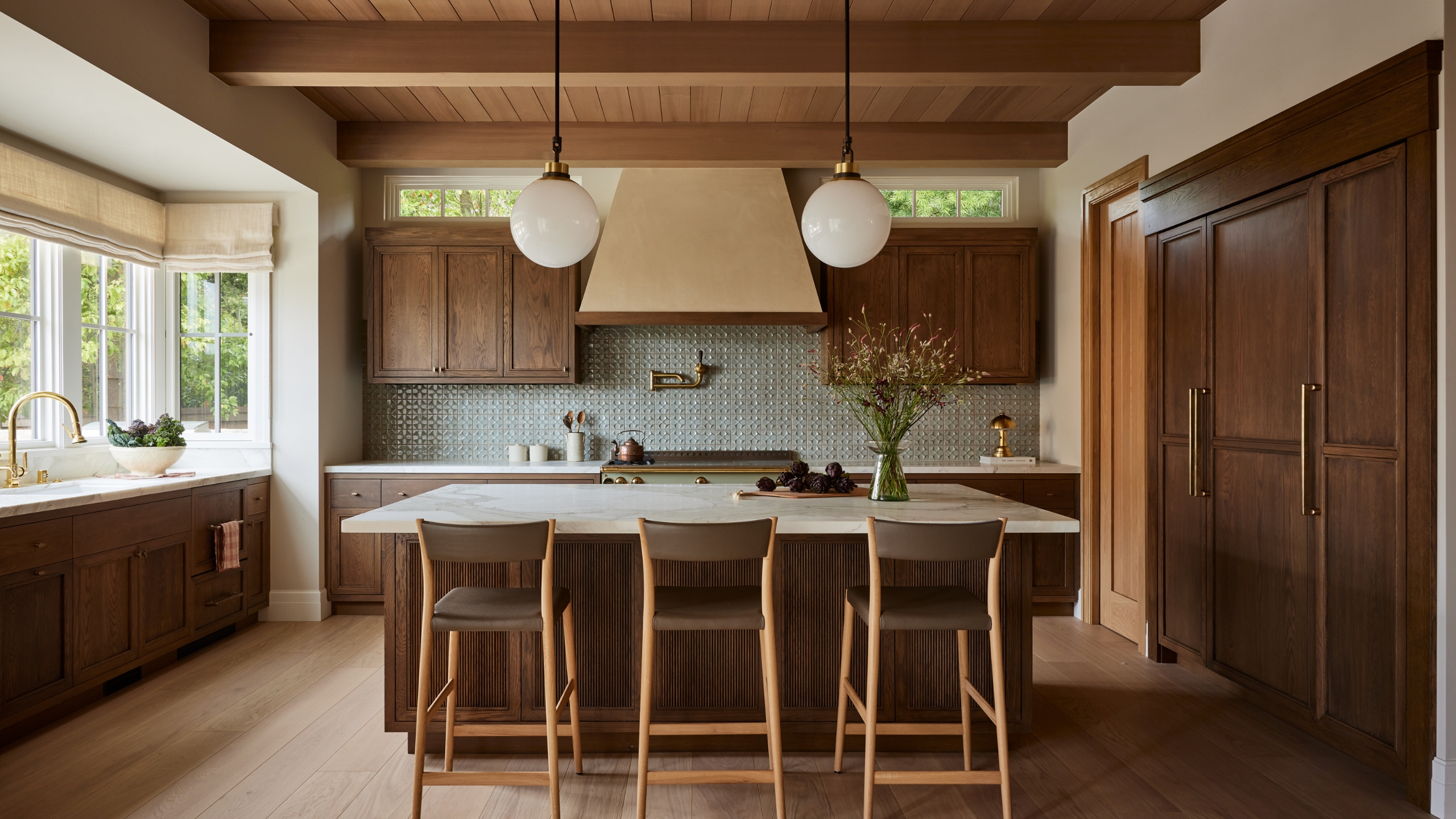 A wooden kitchen with a green tiles backsplash