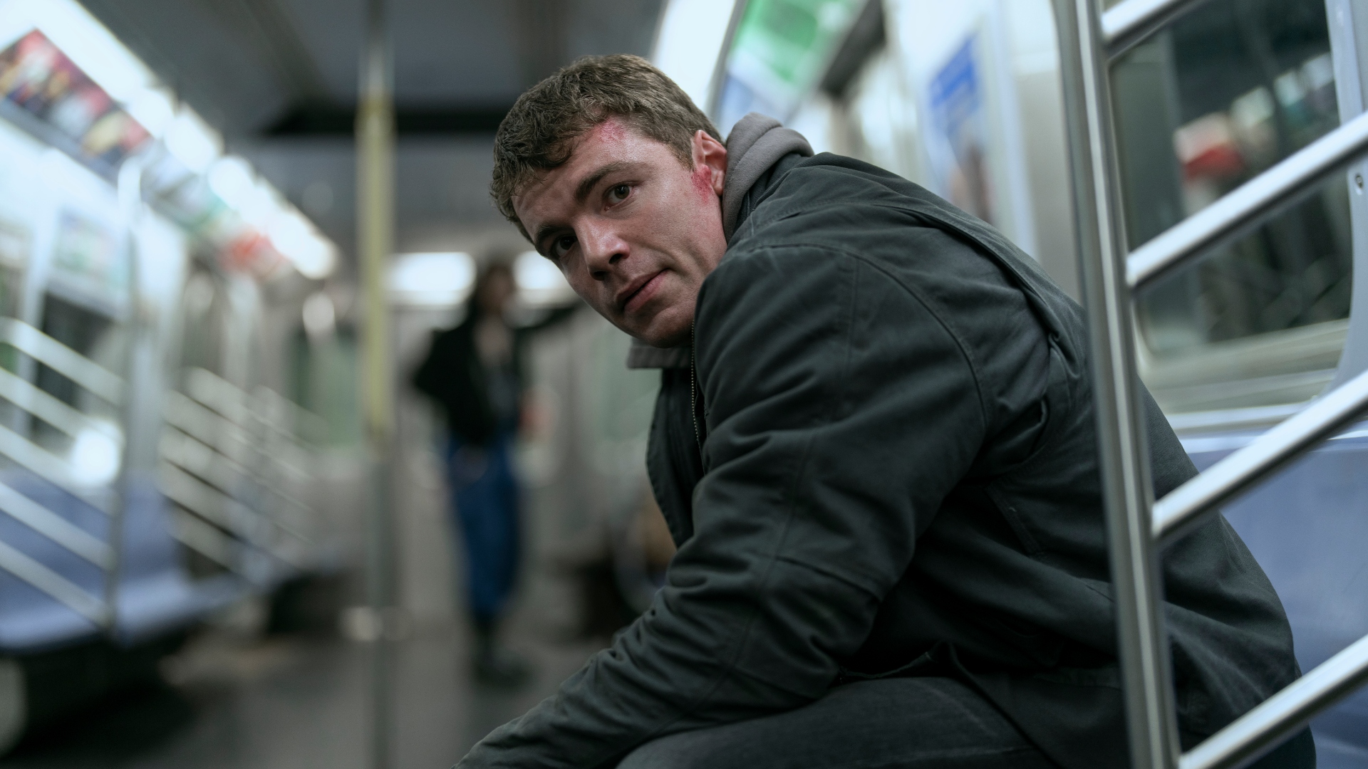 Peter sits on the subway in The Night Agent