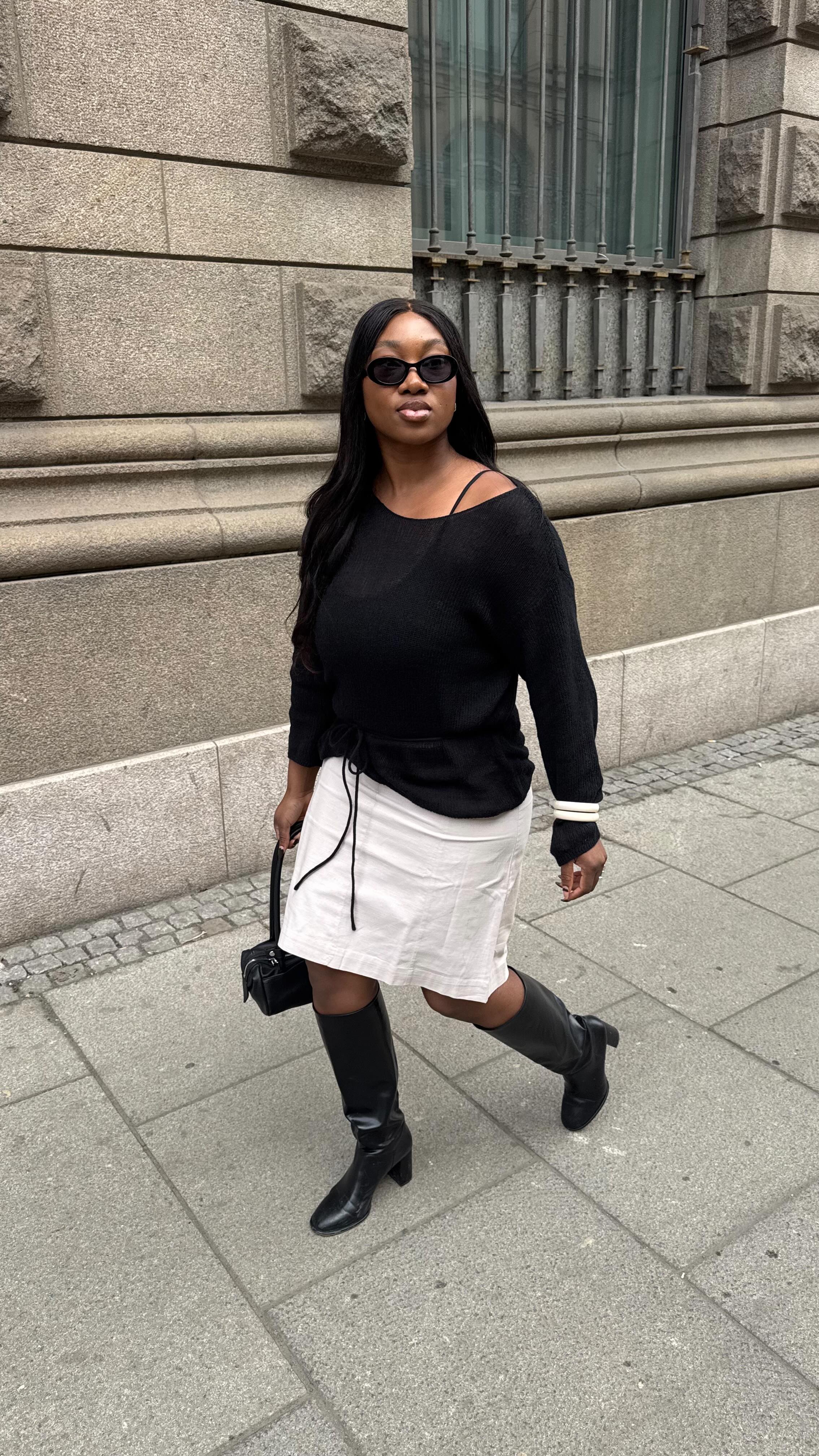 An image of @nnennaechem wearing chunky curved-toe boots, of the biggest boot trends for spring 2026.