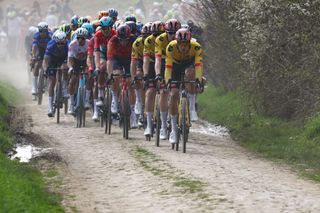 The pack of riders cycles over a cobblestone sector during the 120th edition of the ParisRoubaix oneday classic cycling race between Compiegne and Roubaix northern France on April 9 2023 Photo by AnneChristine POUJOULAT AFP Photo by ANNECHRISTINE POUJOULATAFP via Getty Images