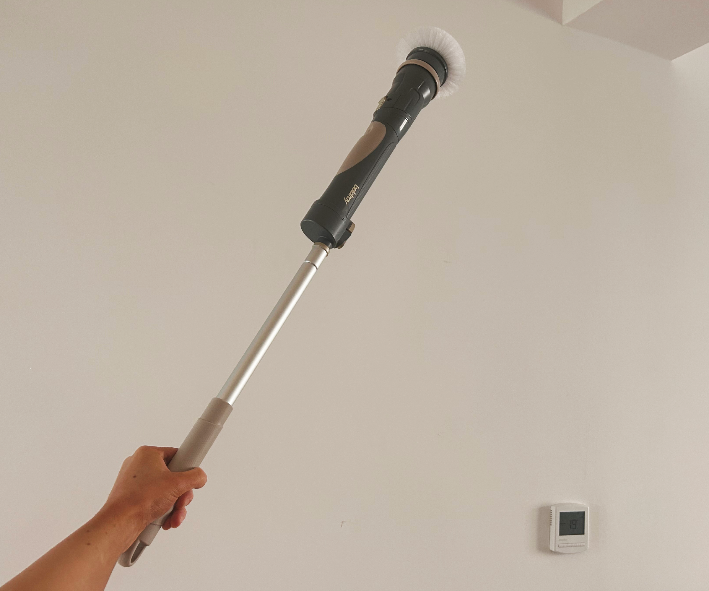 Megan's hand holding the Beldray shower cleaner on the one meter handle