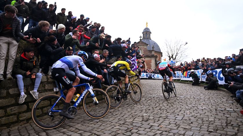 Christophe Laporte, Wout van Aert and Arnaud De Lie climb the Muur van Geraardsbergen in front of big crowds during the 2024 Omloop Het Nieuwsblad. 