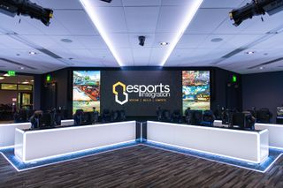 An esports venue a lit in neon lights with gamers POV displayed on an LED screen thanks to Marshall cameras.
