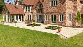 self build house with gravel patio and formal planting