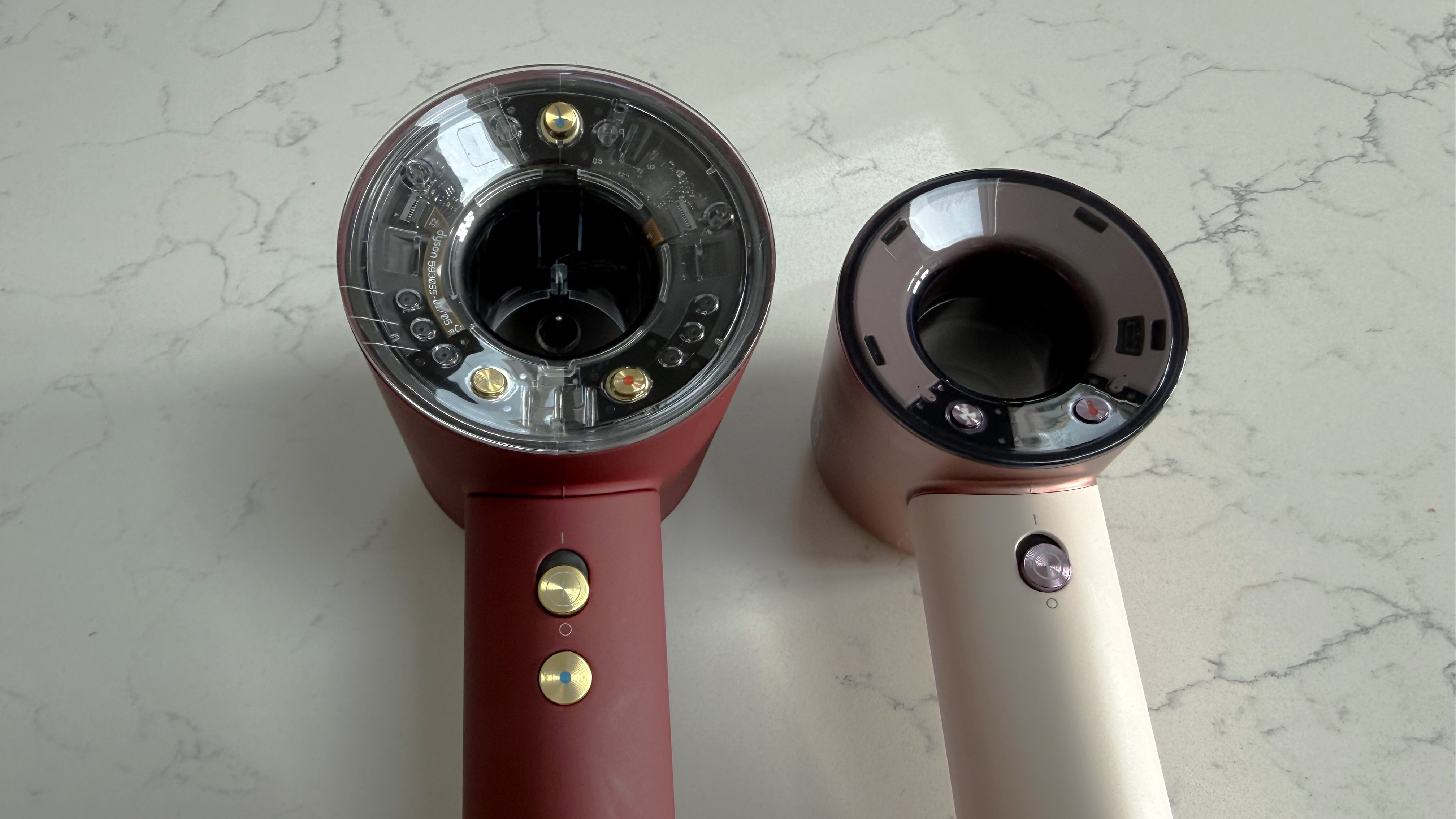 Dyson Supersonic Nural and Supersonic Travel hair dryers compared on a countertop