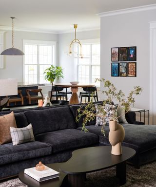 An open-plan living and dining room with a dark gray sectional