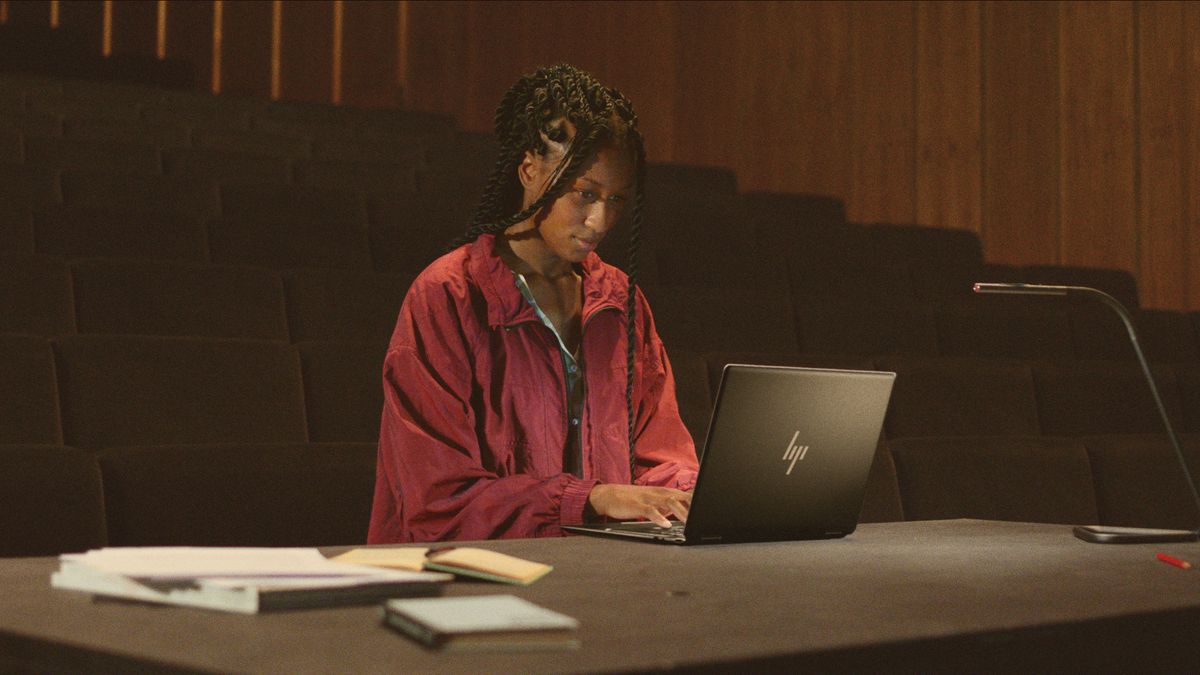 Woman working on laptop in classroom