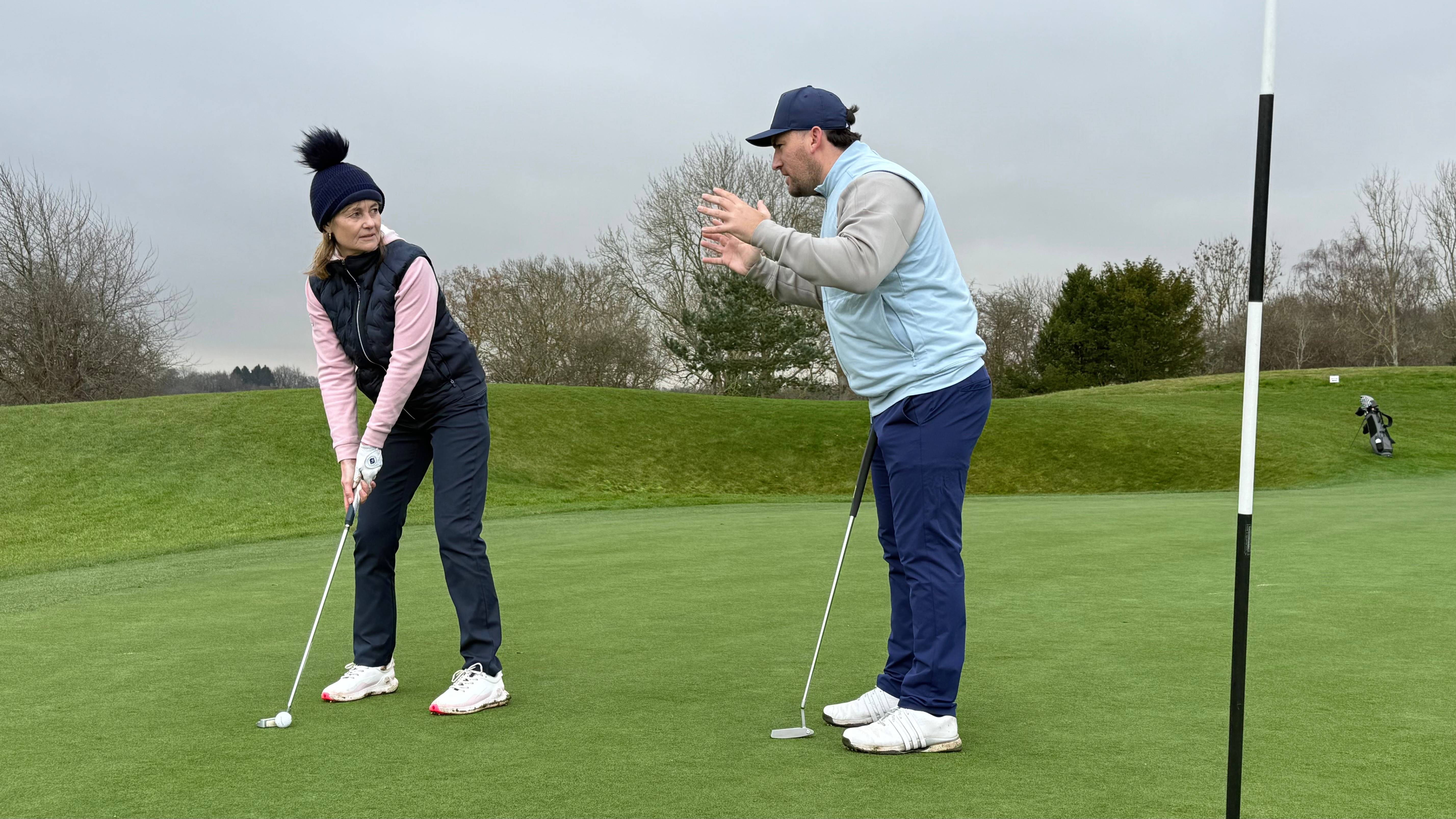 Sam De'Ath giving Alison Root advice on the green