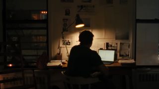 The silhouette of a man sitting at a desk in American Conspiracy: The Octopus Murders