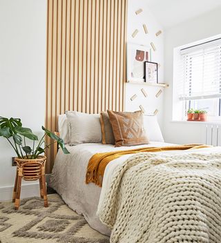 Wooden slats behind bed in bedroom