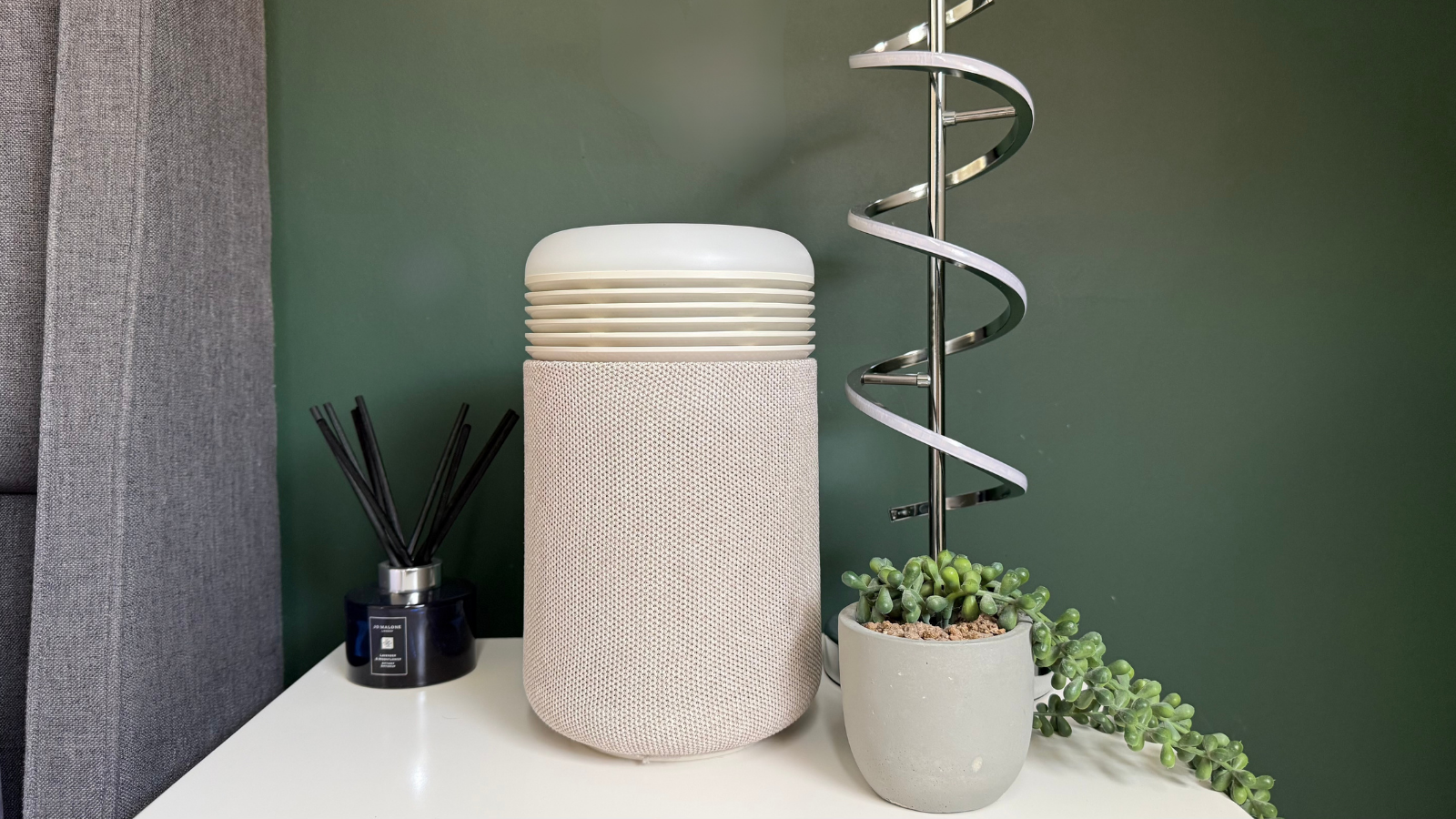 Blueair Mini Restful sunrise alarm clock and air purifier positioned on a bedside table next to home d&amp;eacute;cor