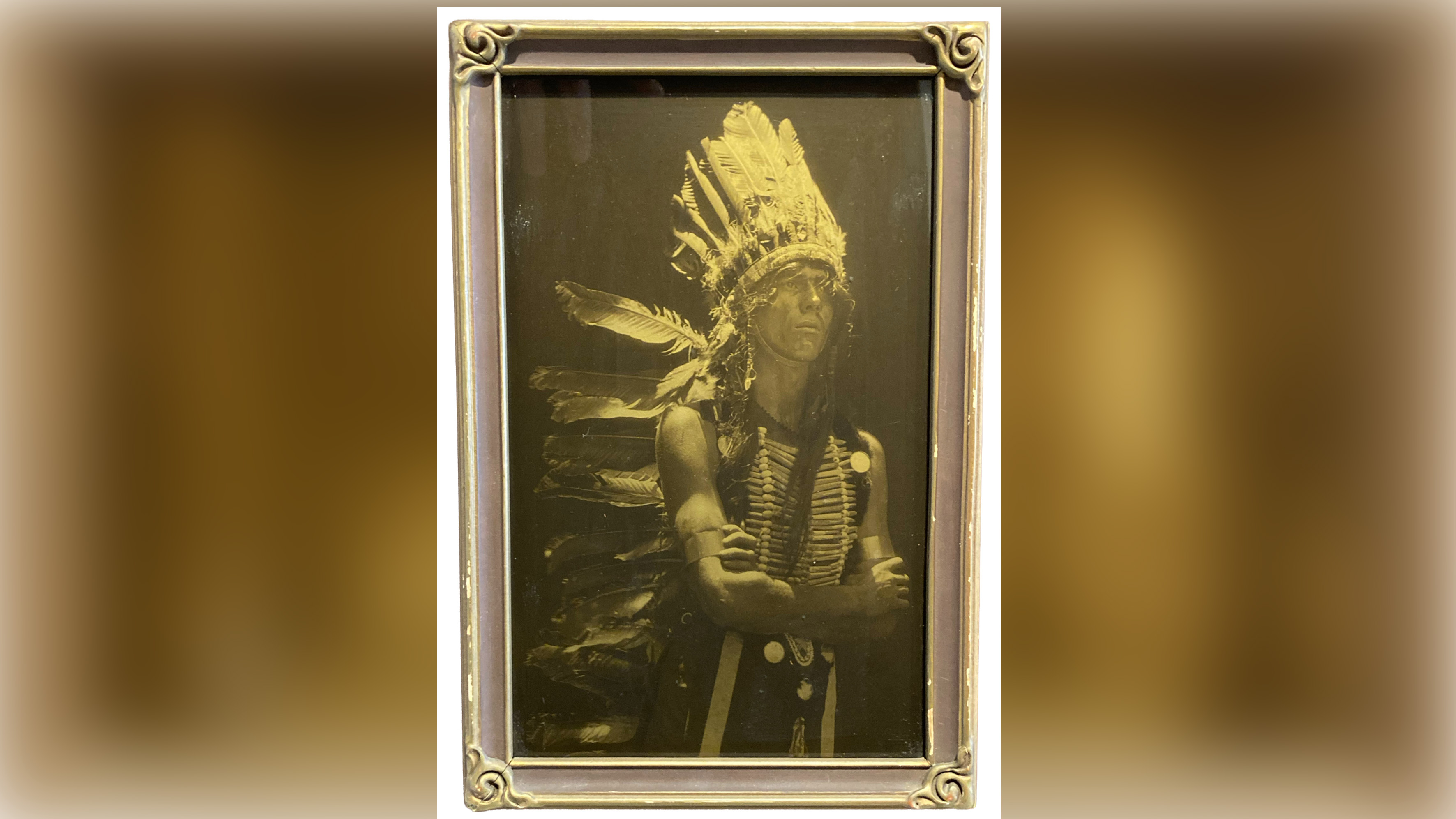A native American Indian chief wearing a feather headdress.