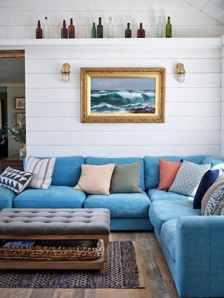 blue corner sofa and white internal timber cladding