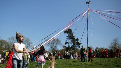 People dancing around the May pole