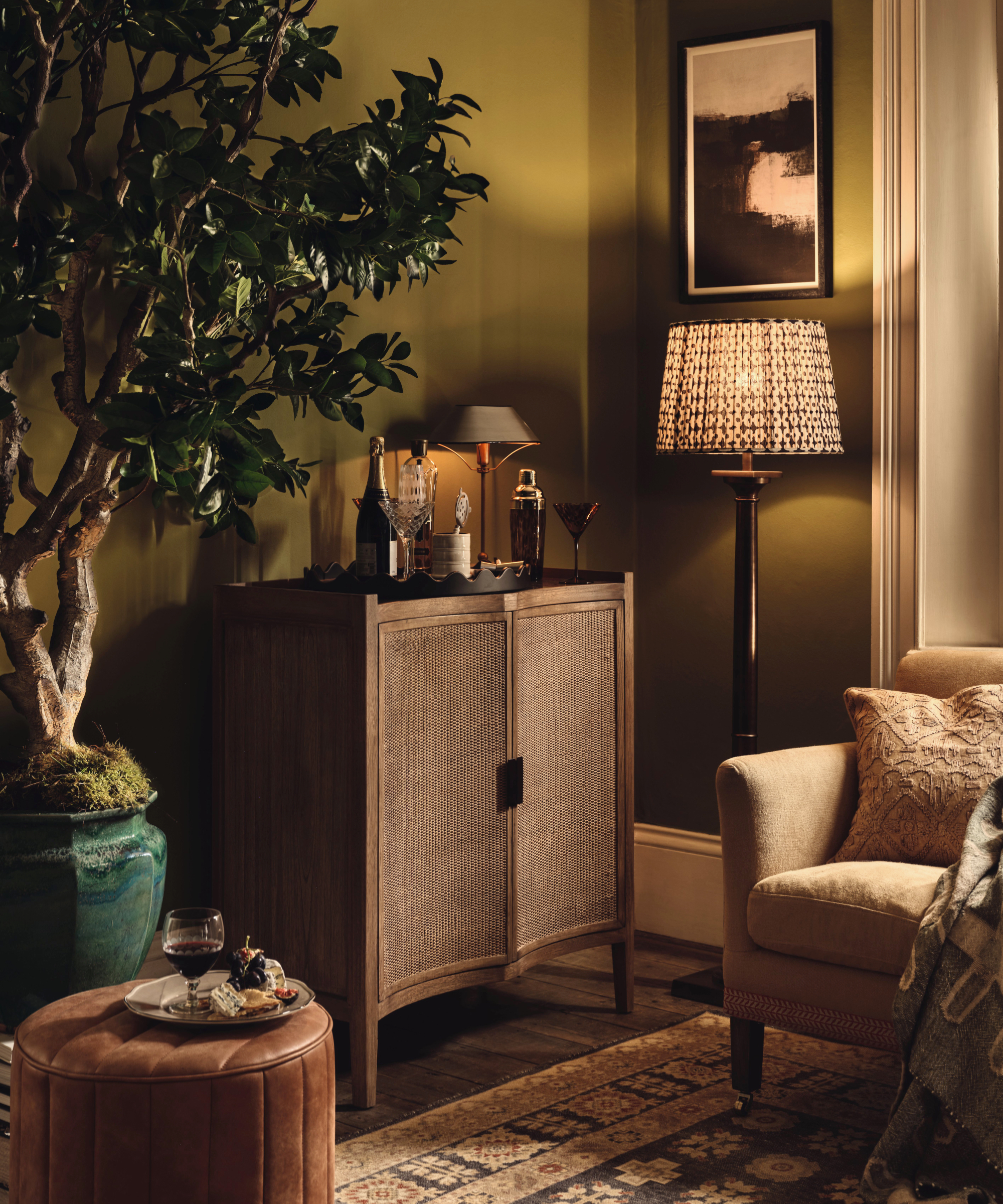 Oka drinks cabinet in olive green living room with lamps
