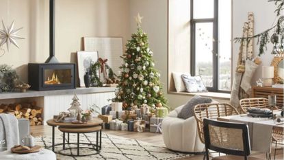 living room with cream walls and light cream furniture and Christmas tree 