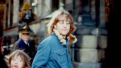 John Lennon in 1977 outside the Dakota building where he lived with his wife and son in New York 