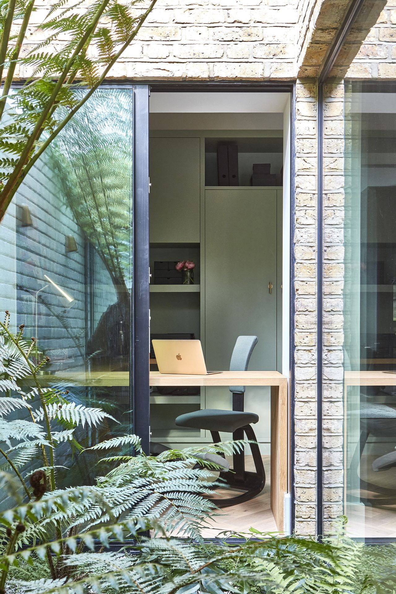A view from the leafy fern garden inside the house
