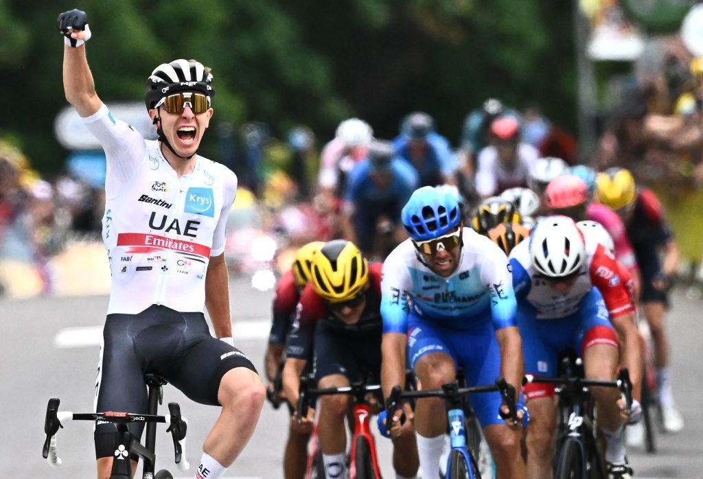 UAE Team Emirates teams Slovenian rider Tadej Pogacar L celebrates as he cycles to the finish line to win the 6th stage of the 109th edition of the Tour de France cycling race 2199 km between Binche in Belgium and Longwy in northern France on July 7 2022 Photo by AnneChristine POUJOULAT AFP Photo by ANNECHRISTINE POUJOULATAFP via Getty Images