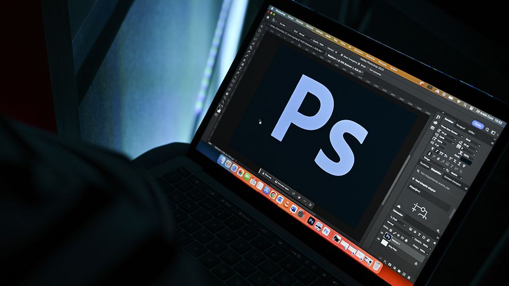 Adobe Photoshop logo in Photoshop on a laptop