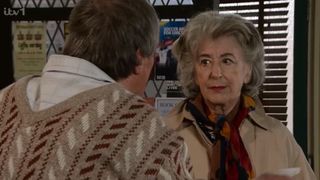 Roy talks to Evelyn in the cafe while wearing his v neck jumper back to front in Coronation Street