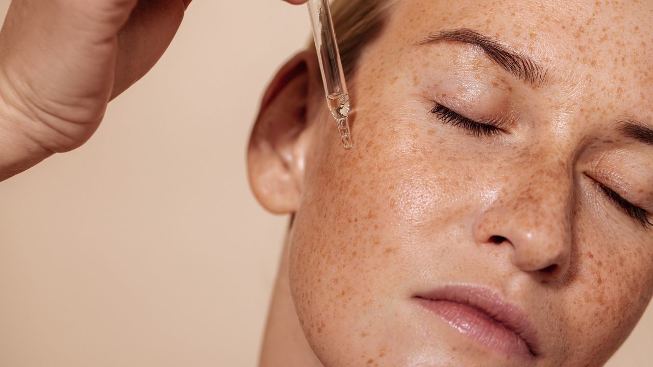 woman applying azelaic acid serum