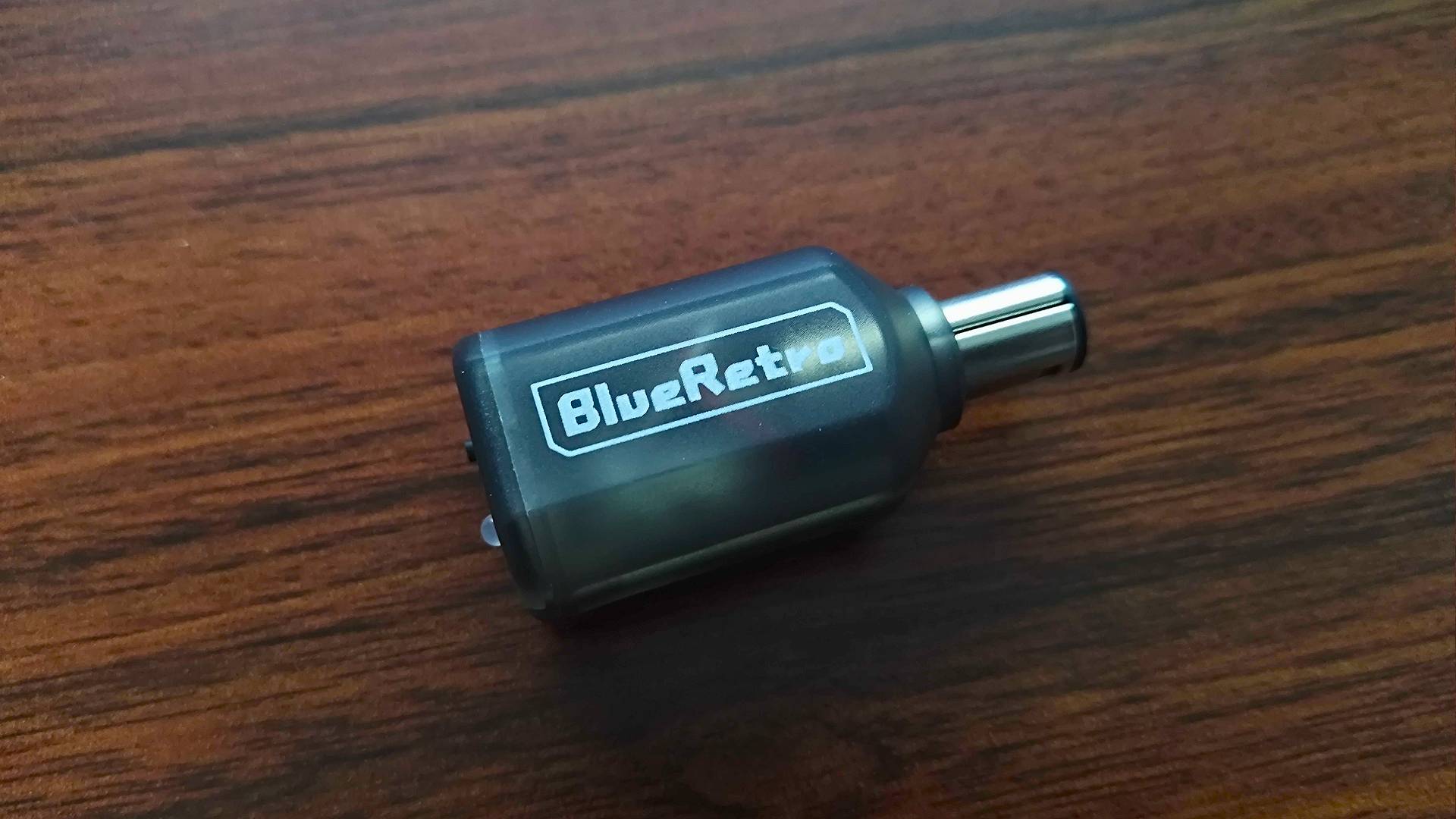 Blueretro GameCube Controller Adapter box on woodgrain desk.