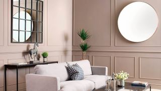 neutral living room with cream sofa and large mirrors